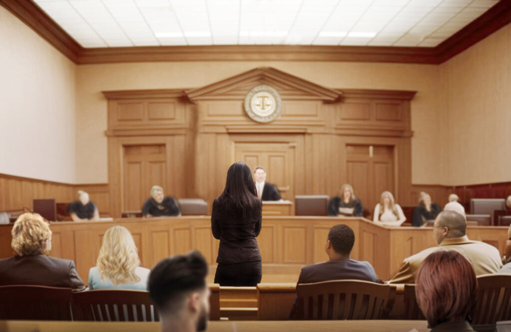 A woman stands before a courtroom | Allen Fischer PLLC